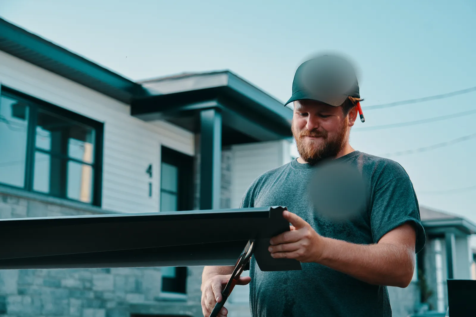 Installer preparing a seamless gutter run — JAWZ Gutter Solutions, Victoria BC