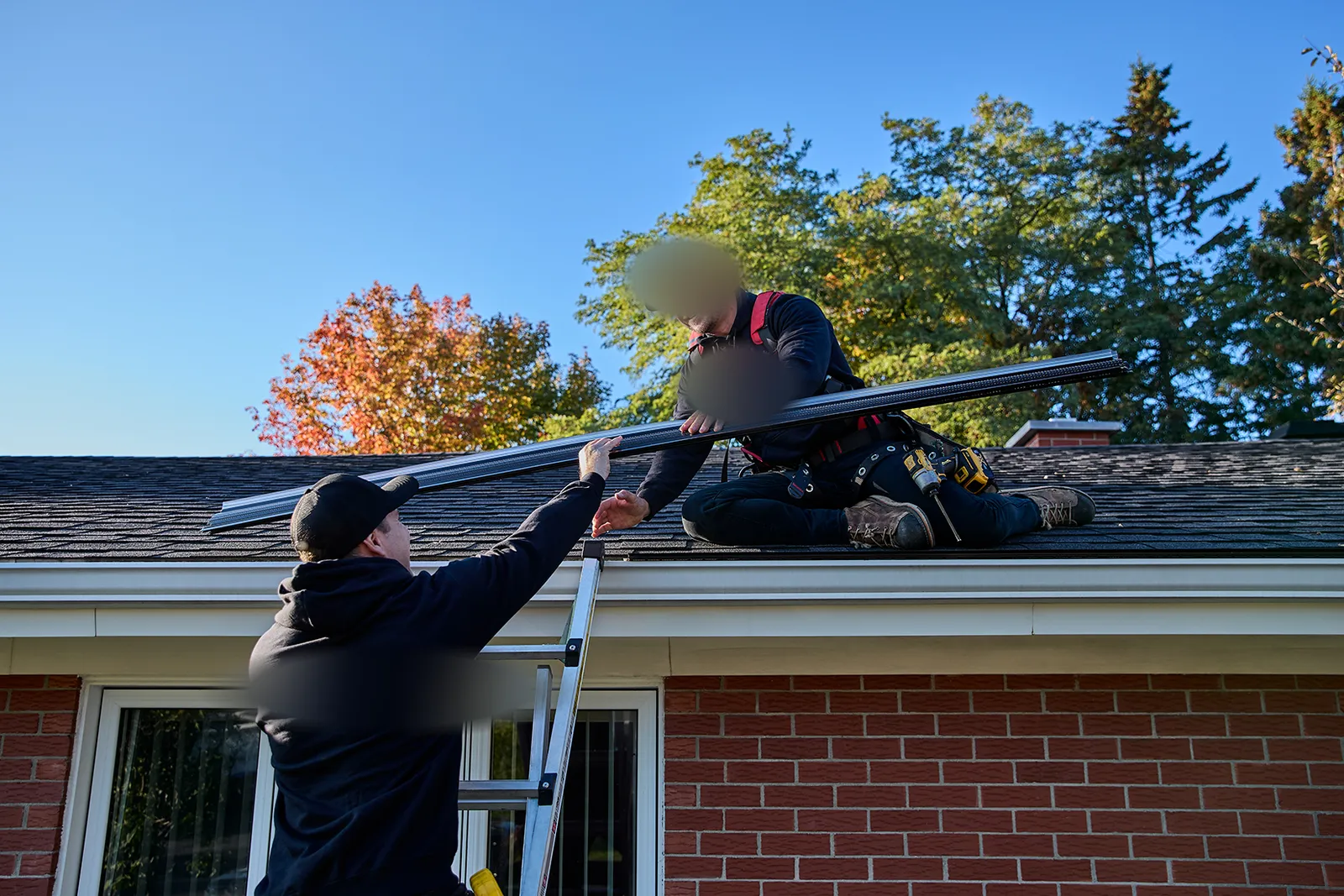 Team handing up gutter stock on site — JAWZ Gutter Solutions, Victoria BC